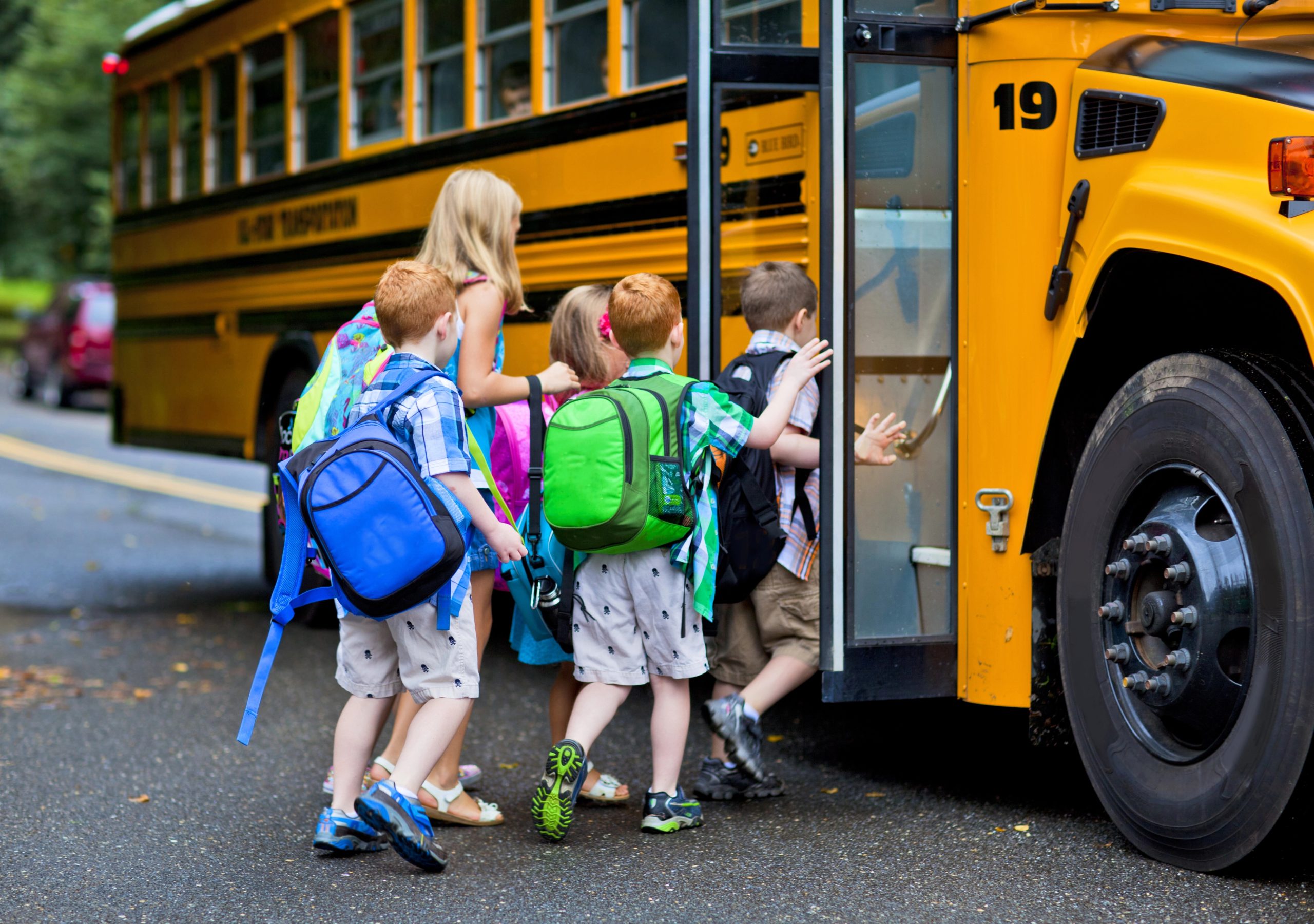 school bus - Warshafsky Law Firm Milwaukee, Wisconsin - Warshafsky Law Firm Milwaukee, Wisconsin Children with colorful backpacks boarding a yellow school bus outdoors, door open Warshafsky Law Firm Milwaukee, Wisconsin Warshafsky Law Firm Milwaukee, Wisconsin